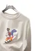 Camiseta de Manga Longa de Algodão Puro com Gola Redonda, Padrão de Desenho Animado com Letras, Corte Solto, Estilo Coreano Novo, Primavera e Outono de 2026 para Mulheres, Camiseta Básica Tendência