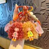 Chaveiro Pingente Menina Cabelo Cacheado Moderno Legal Desenho Animado Boneca Pão de Leite Charme para Bolsa Feminina Argola Pequeno Presente