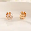 Artículo popular pendientes de trébol de cuatro hojas ojo de gato diseño de nicho pendientes pequeños temperamento a la moda versátiles pendientes pequeños frescos