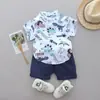 Ropa para Bebés Niños 0-3 Años Bebé Niño Verano Manga Corta Camisa Estampada de Dinosaurio Cuello Henley + Pantalones en Stock