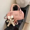 Diseño de Nicho Bolsa de Bowling de Mano 2026 Nueva Bolsa de Trabajo para Mujer Commute Tacto de Alta Gama Lujo Ligero Bolso Cruzado