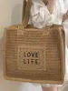 2026 Nuevo Estilo Bolso de Paja Color Sólido Tejido con Letras Personalizadas Bolso de Hombro Tote de Gran Capacidad Casual para Vacaciones Estilo Pastoral