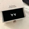 Pendientes dulces de estilo francés de lujo ligero de alta gama con circonita en forma de gota de agua y lazo para mujer, con un diseño tridimensional, exquisito y moderno.