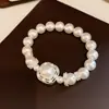 Pulsera de perlas con flor hueca de circonita blanca y brillante, sensación de lujo ligero de alta gama, accesorio de muñeca vintage francés