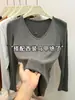 Moda feminina popular deste ano: Coleção outono 2026, camiseta de manga longa com decote V, corte slim, que valoriza a silhueta, top para usar por baixo