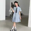 Vestido de Verano para Niñas 2026 Nuevo Elegante Estilo Universitario Vestido Camisa a Cuadros con Cuello Polo para Niños Mayores Moderno