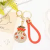 Llavero Colgante de Bolsa de la Suerte Flor de Ciruelo Popular Transfronterizo con Pedrería, Cordón de Cuero Metálico que Atrae la Fortuna, Decoraciones de Año Nuevo al por Mayor