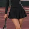 Mono de tenis de estilo europeo y americano más vendido, de manga larga con media cremallera en color marrón oscuro, para fitness al aire libre, con pantalones cortos de seguridad incorporados
