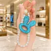 Llavero personalizado de cabeza de conejo hueca estilo coreano con pedrería completa, cadena de perlas de alta gama, colgante de moda para bolso, cadena para colgar del teléfono móvil