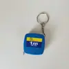 Venta al por mayor de fábrica cinta métrica mini de acero de alta calidad color negro puro 1 metro regla de cinta de acero regalo de publicidad con logo