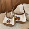 Bolso de cuadros de nicho exquisito y moderno para mujer, nuevo modelo 2026, minibolso cruzado versátil, bolso tipo dumpling, bolso de mano pequeño para salir
