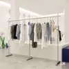 Estante de exhibición para tienda de ropa de pie de acero inoxidable plateado estante de exhibición minimalista estante isla para ropa de mujer perchero para ropa de niños