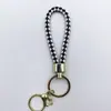Venta al por mayor del fabricante Llavero de Cuerda de Aleación Tejida y Cuero Accesorios Colgantes Material PU Bolsas Pequeñas de Regalo Accesorios para Llaveros