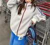 Moletom com Capuz Listrado Versátil Americano para Homens e Mulheres 2026 Novo Estilo Cardigan Esportivo Solto Casual Jaqueta com Zíper Tendência
