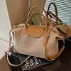 Bolso pequeño de alta gama transfronterizo para mujer, estilo verano 2026, moderno y sencillo, bolso tipo empanada de nicho, bolso versátil para hombro y cruzado