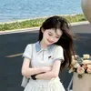 Nuevo conjunto de verano estilo universitario para niñas: Conjunto de dos piezas estilo coreano dulce y lindo de camiseta tipo polo de dibujos animados con minifalda de encaje