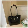 Bolso de hombro con lazo estilo coreano 2026 transfronterizo para mujer, bolso de axila de nicho, bolso tipo cubo moderno y simple para el trabajo diario para mujer