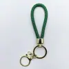 Venta al por mayor del fabricante Llavero de Cuerda de Aleación Tejida y Cuero Accesorios Colgantes Material PU Bolsas Pequeñas de Regalo Accesorios para Llaveros