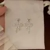 Pendientes de moda personalizados de alta gama con perla de circón, dulces y elegantes, con lazo hueco y tachuelas en forma de corazón para mujer