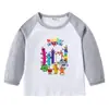 2026 Nova Camiseta Infantil Transfronteiriça Primavera e Outono Gola Redonda Desenho Animado Manga Longa Camisa Básica para Meninos e Meninas Camiseta de Algodão para Bebê