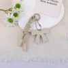 Llavero Colgante Creativo Nuevo Estilo Miu de Cuero con Lazo para Coche, Bolsas y Fundas de Teléfono, Versátil para Parejas