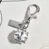 Nuevo Colgante Metálico Rosa Plateado Forma de Corazón Botella de Perfume de Cereza Llavero Accesorio Versátil para Bolsa Venta al por Mayor Dropshipping