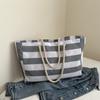 Lona a rayas casual moda 2025 personalidad elegante estilo moderno gran capacidad para ir al trabajo bolsa de hombro con cordón para mujer