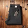 Estación europea otoño e invierno pantalones de lana elástica para hombre cepillados engrosados cálidos rectos holgados de negocios sin planchado pantalones casuales