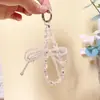 Corrente de pulso para celular com laço e contas de cristal, acessório de chaveiro de carro para capa de celular