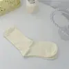 Meias brancas femininas outono e inverno meias de cano alto cor sólida japonesa meias de cano longo folgadas meias para o mês pós-parto de mulheres grávidas atacado