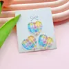 Nuevo fresco botón de amor de cuatro agujeros accesorios diy ropa de niños accesorios de botón de abrigo corazón de melocotón multicolor venta al por mayor