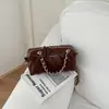 Bolso de mano de cadena con patrón de rombos retro, diseño cilíndrico, colección de otoño para mujer, chic y lujoso, versátil, y exuda una sensación de alta gama, adecuado para llevar al hombro o cruzado