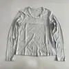Camiseta de manga larga estilo perezoso para mujer, cuello redondo, nuevo estilo de otoño, para el día a día, color liso, versátil, transpirable, top para capas, top elástico