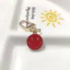 Llavero de cara sonriente de color aleación con goteo transfronterizo de comercio electrónico, accesorios de colgante para bolso con expresión irregular chapado en oro
