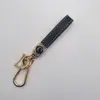 Llavero Nuevo para Coche Cuerda de Llave Exquisita de Alta Gama Llavero con Relieve de Rombo Logo del Coche Colgante con Hebilla de Metal Venta al por Mayor