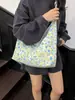 Bolsa de lona de gran capacidad para mujer, nuevo modelo 2026, estilo commuter de alta gama, estampado floral dulce, bolso tote de un solo hombro para llevar debajo del brazo