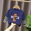 Camiseta de manga larga de algodón puro para niño 2026 primavera y otoño nueva elegante de dibujos animados estilo dos piezas falsas camiseta base de primavera para niño