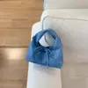 Bolsa de Mão Pequena Texturizada de Nicho Atacadista Transfronteiriça para Mulheres 2026 Nova Bolsa de Balde Simples Versátil Bolsa de Ombro Transversal