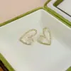Nuevos Pendientes de Corazón Hueco con Pedrería para Mujer, Pendientes de Botón de Diseño de Nicho de Lujo Ligero, Accesorios Versátiles para Pendientes de Celebridad de Internet