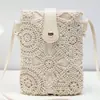 Venta caliente transfronteriza 2026 bolsos de dama nuevos huecos color sólido bolso cruzado para mujer bolso de playa de paja para teléfono