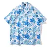 Cuello de solapa 2026 Estilo nuevo Camisa floral para hombre Estilo coreano Holgada Moda Estampada Estilo playero Casual Camisa de manga corta Exportación