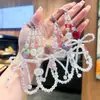 Cadena para Teléfono de Fresa de Cristal Iridiscente con Lazo de Pedrería Brillante, Correa de Muñeca Antiperdida, Llavero Encanto de Bolsa Femenino