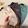 Calça Comprida Infantil 2026 Nova Coleção Primavera Meninos e Meninas Calça com Cordão Color-Blocking Calça para Bebê com Cinto de Letras