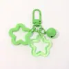 Colgante de llavero de campana doble estrella color caramelo personalidad dopamina colgante versátil embalaje de funda de teléfono accesorios de joyería