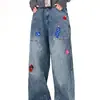 Jeans divertidos bordados estilo americano para hombres y mujeres, pantalones largos de otoño de moda callejera ligeramente acampanados con un diseño elegante y perneras anchas