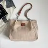 Bolso de mujer 2026 otoño nuevo estilo coreano mochila escolar para estudiante bolso de hombro simple y moderno bolso tote de gran capacidad para ir al trabajo