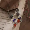 Pendientes Largos Personalizados de la Fábrica Jinqi Estilo Chino Nuevo Flor Pequeña Hueco Azul Quemado Borla para Mujer Pendientes Estilo Étnico Vintage