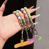 Correa de anillo superestilosa con bloques de color, duradera y resistente con un gancho de metal, un cordón para teléfono anti-pérdida para mujer para ir de compras