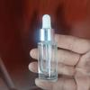 En stock 10 ml30ml50ml botella cilíndrica transparente para aceite esencial botella de despliegue para subempaque de cuidado de la piel botella con gotero para esencia líquida