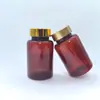 Directo del FabricanteBotella de PET marrón para productos de salud con tapa dorada, botella para cápsulas, botella de plástico para productos de salud disponible